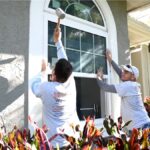 Storm Tight team pounding windows into place